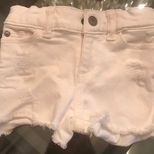 Distressed white denim shorts